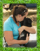 veterinarian snuggling with a puppy outside